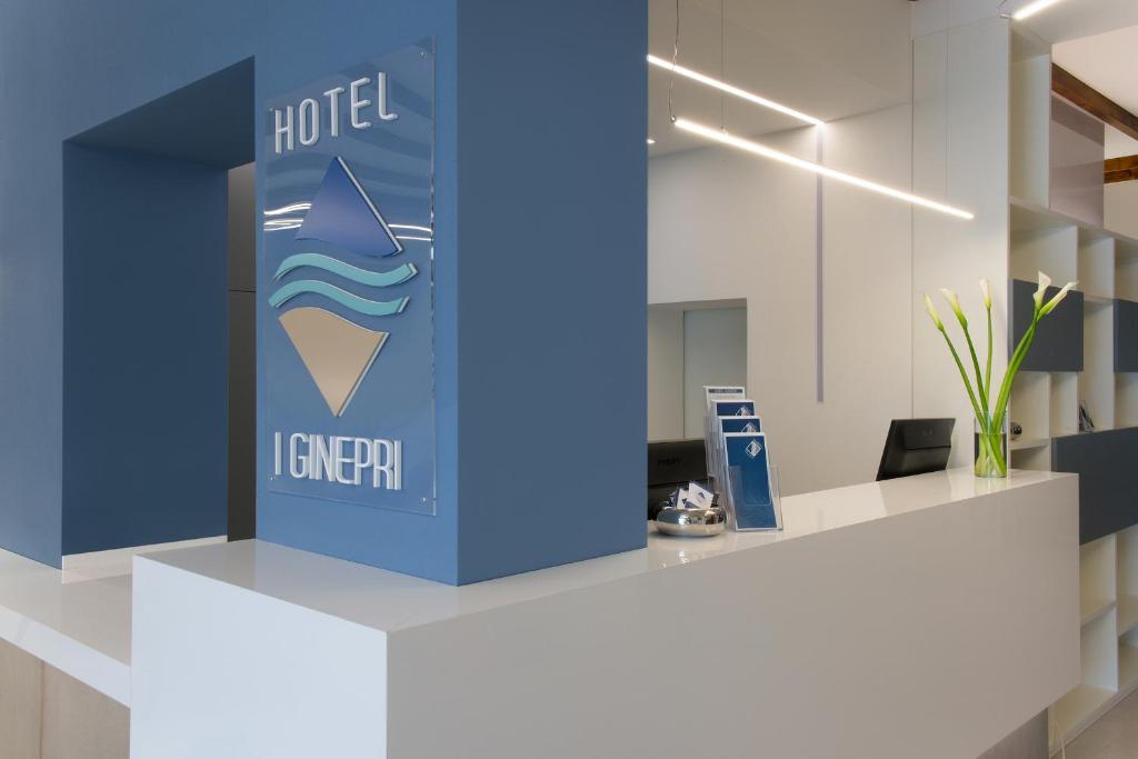 an office lobby with a blue ice cream sign at Hotel I Ginepri in Marina di Castagneto Carducci