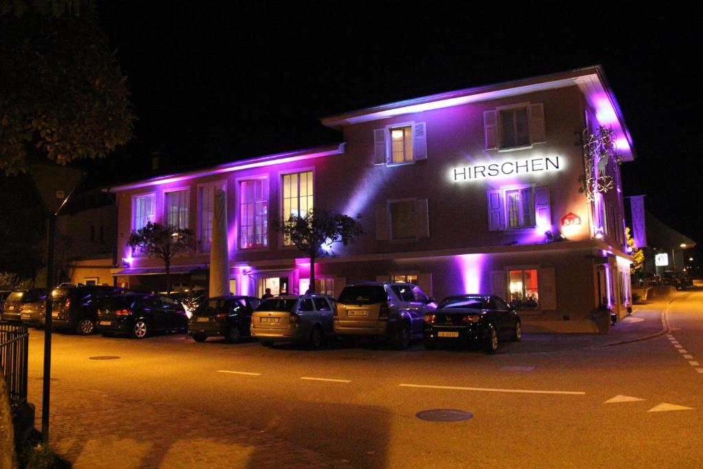 a lit up building with purple lights on it at Landgasthof Hirschen in Diegten