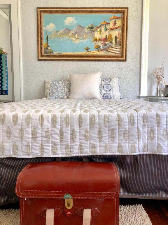 a bed in a room with a painting on the wall at Comfy and Spacious Suite with Free Parking in Miami