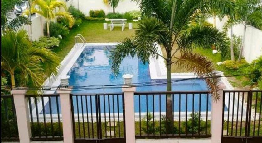 a view of a swimming pool from a balcony at L & R Staycation in Imus