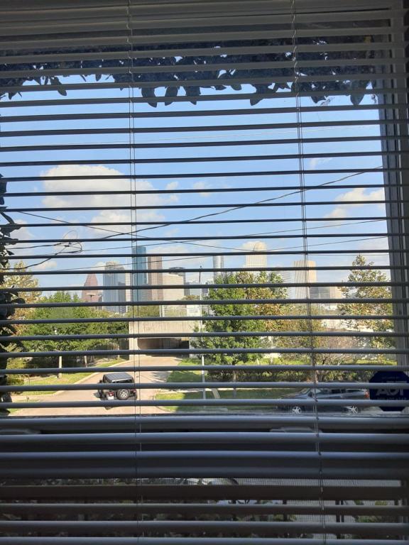 a window with a view of a car in a parking lot at Cozy Studio in the Downtown/Montrose area in Houston