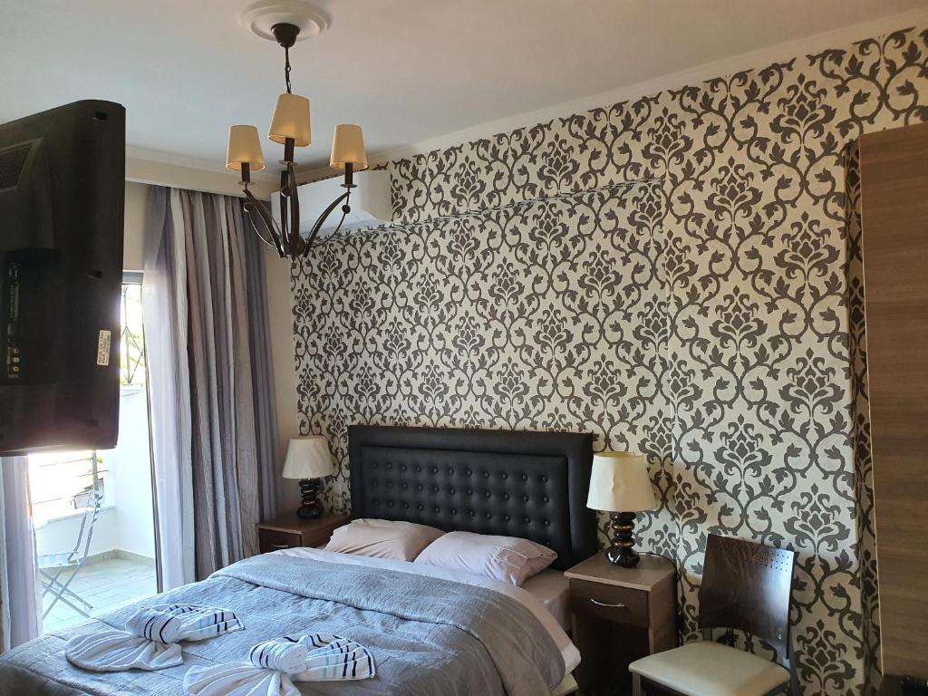 Postel nebo postele na pokoji v ubytování Delfini Hotel