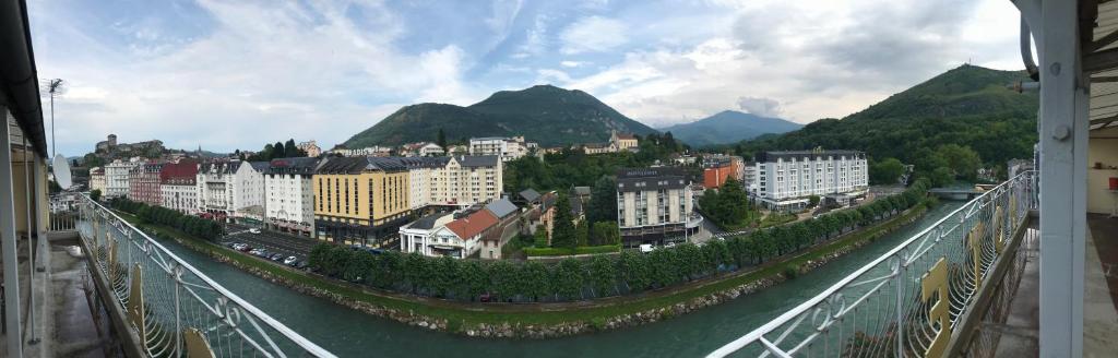 a view of a city from a bridge over a river at Hotel Du Gave in Lourdes