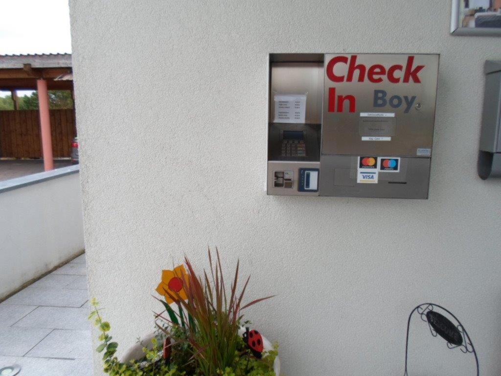 a check in box on the side of a building at Hotel Frankenhöhe in Aurach