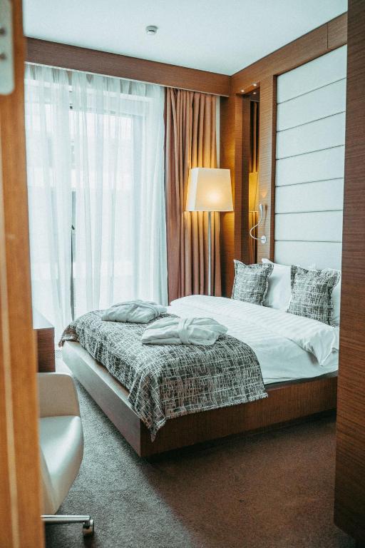 a bedroom with a large bed and a window at Arfa Park-Hotel in Adler