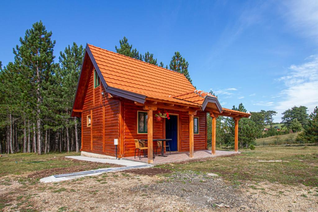 a small wooden cabin with an orange roof at Brvnara Kovacevic in Zlatibor