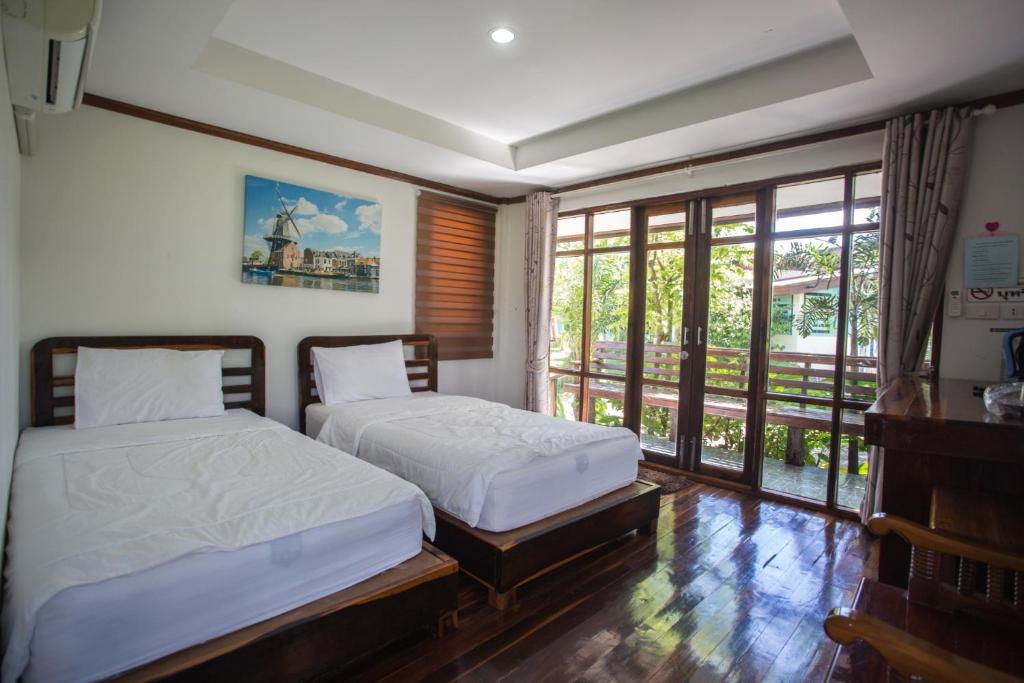 Postel nebo postele na pokoji v ubytování Muangway Garden Ville