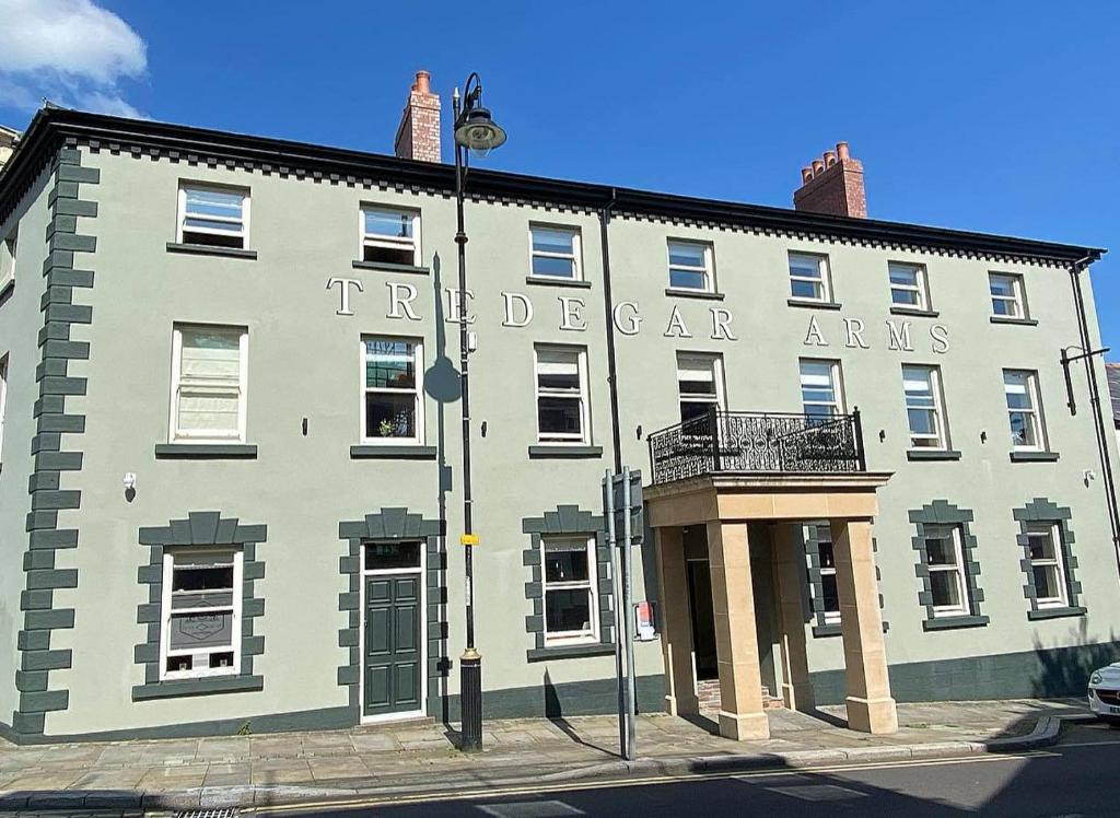 a large white building with a sign on it at Tredegar Arms Hotel in Tredegar