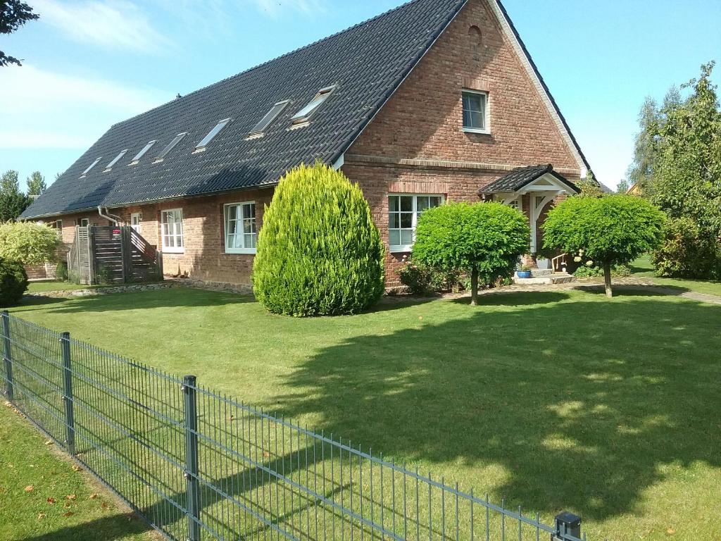 a large brick house with solar panels on its roof at Ferienwohnung Paula, Kluis in Gagern