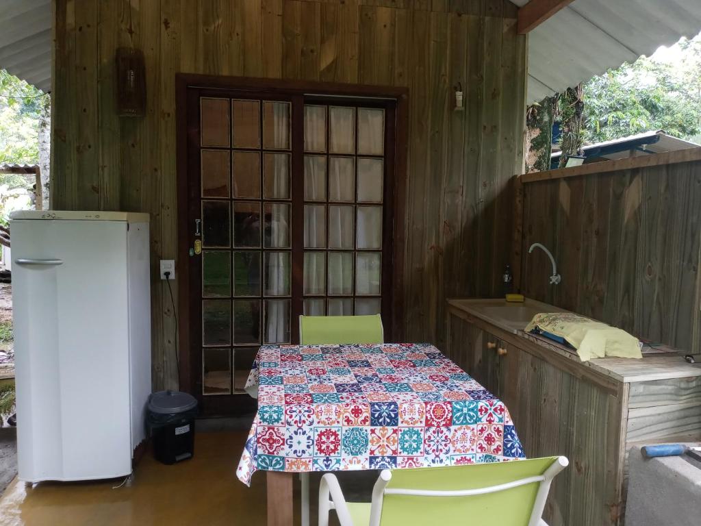 a kitchen with a table and a refrigerator at Bintang Bangalos in Camburi