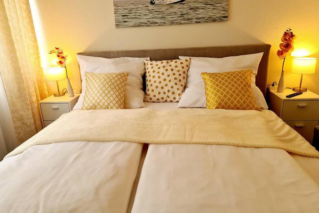 a large white bed with pillows in a bedroom at Rivulet 2 bedroom Apartment in Baden-Baden