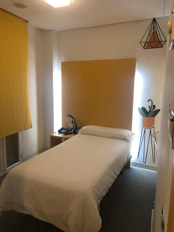 Posteľ alebo postele v izbe v ubytovaní Hostal Albany