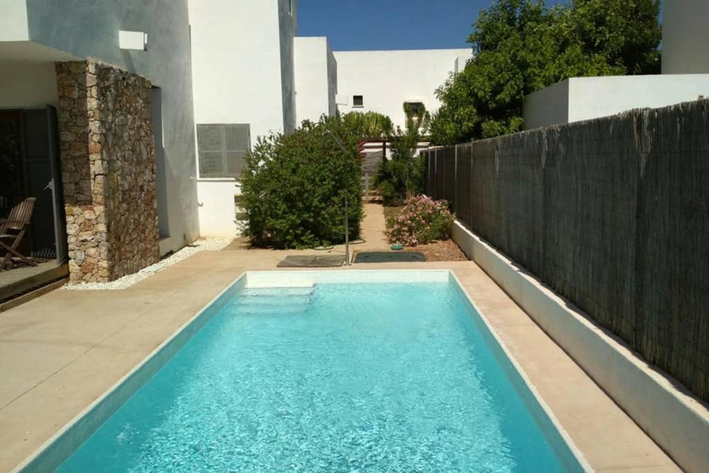 a swimming pool in the backyard of a house at Casa Esparto in Rodalquilar