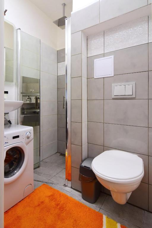 łazienka z toaletą i pralką w obiekcie Apartman Nikola Trojanovice w mieście Trojanovice