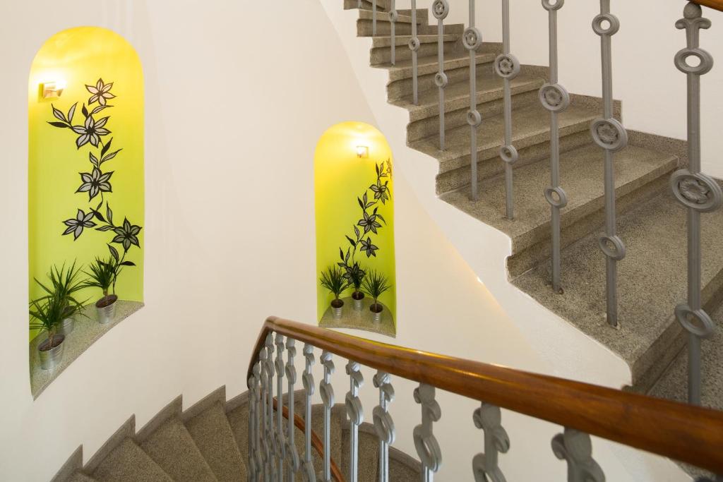 a staircase with a yellow skateboard on the wall at Hotel Páv in Prague