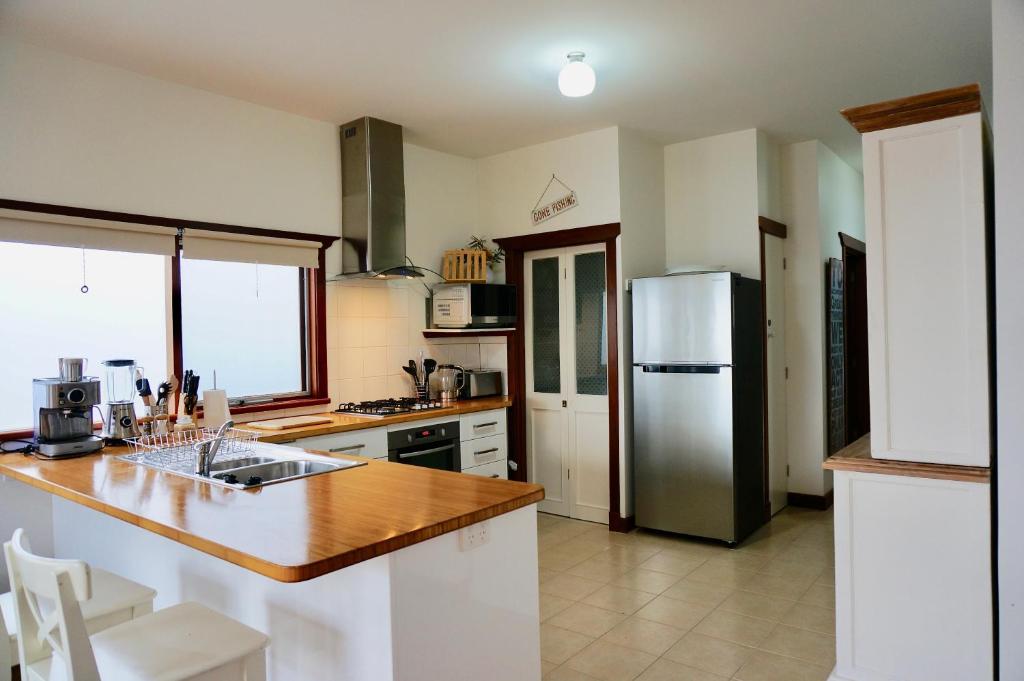 a kitchen with a counter and a refrigerator at Bluey's in Queenscliff