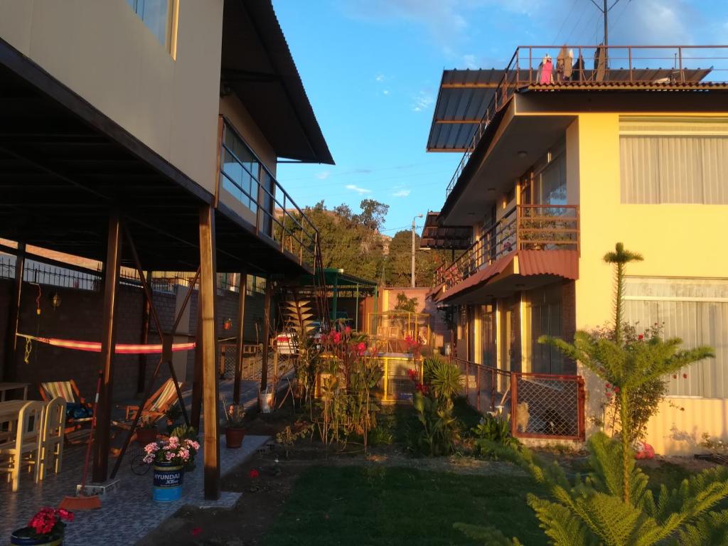 a courtyard of a building with chairs and plants at Casa huerta Stuber in Arequipa