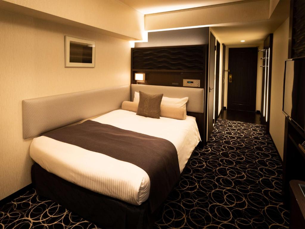 Postel nebo postele na pokoji v ubytování Hotel Bellclassic Tokyo