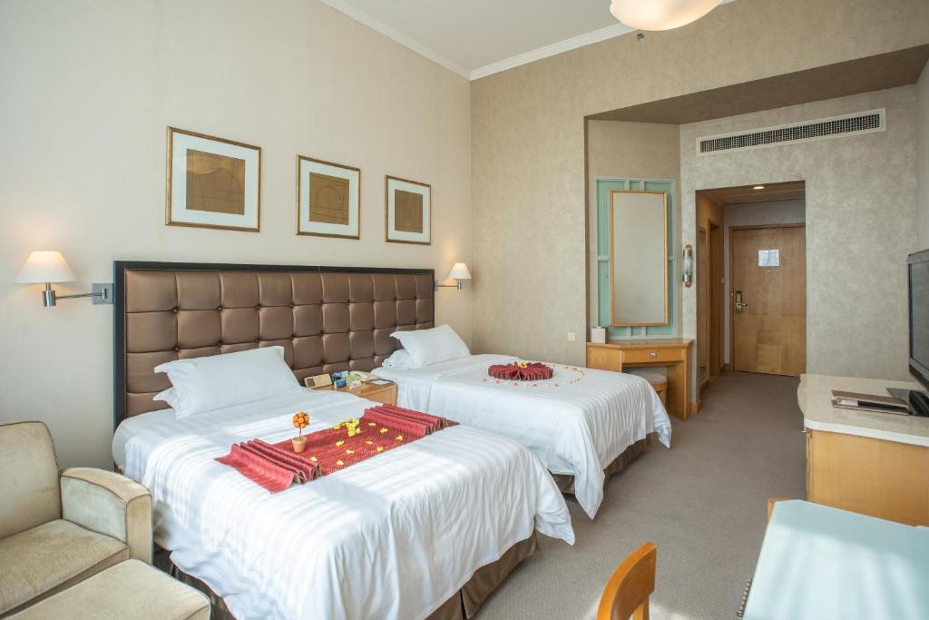 Postel nebo postele na pokoji v ubytování Shantou Junhua Haiyi Hotel