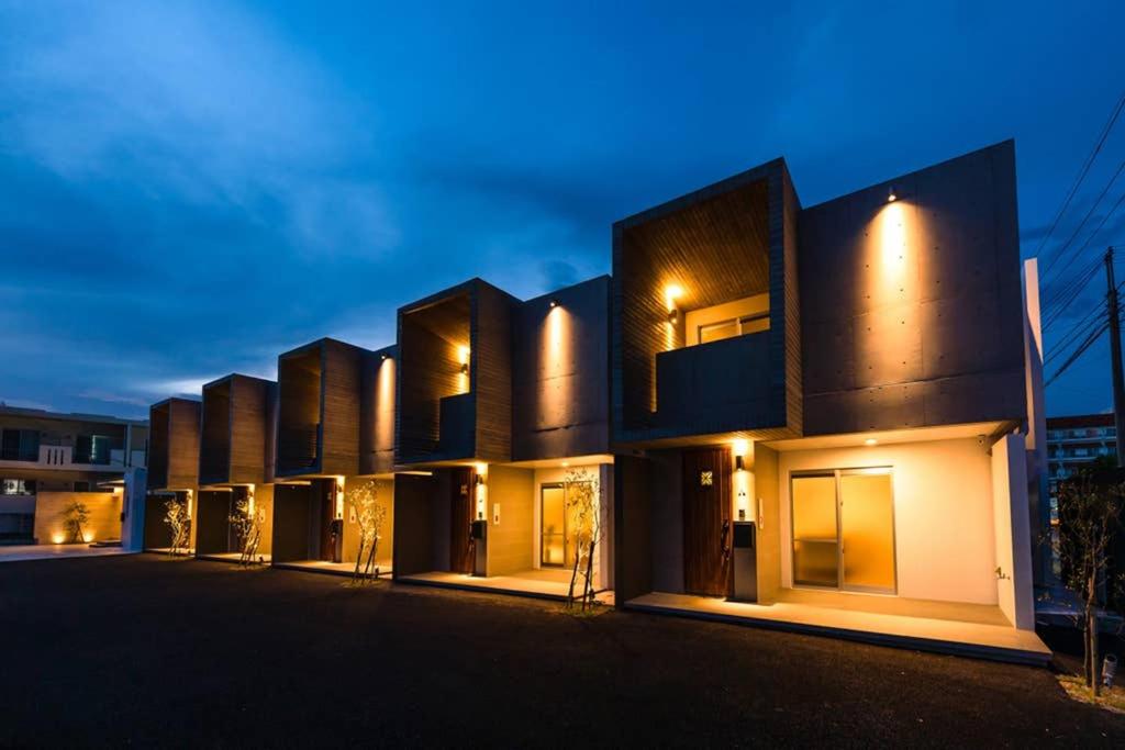 a row of buildings at night at D-and Stay HH.Y Resort Okinawa in Teruya