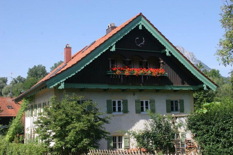 a house with flower boxes on the top of it at Ferienwohnung Wagnerhaus in Bad Reichenhall