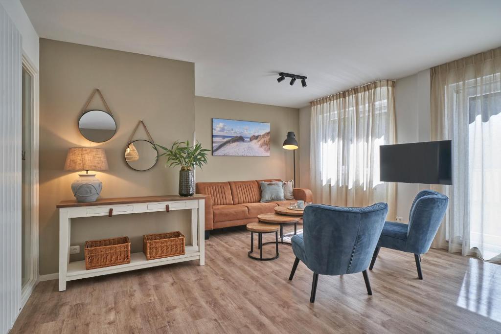 a living room with a couch and a table at Apartments Four Seasons Zuiderstraat in Egmond aan Zee