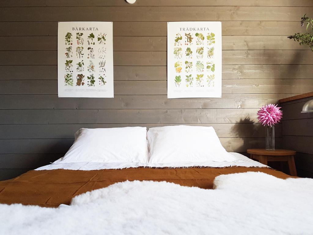 a bed in a room with two posters on the wall at Topperyd Bed & Breakfast in Nässjö