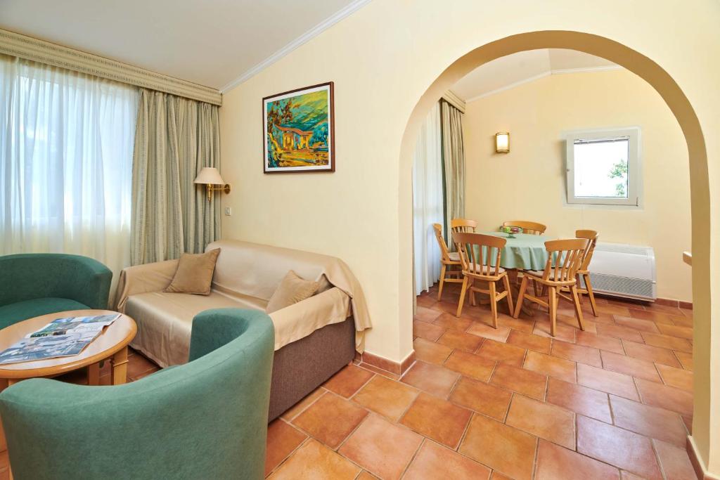 a living room with a couch and a table at Apartments Bellevue Plava Laguna in Poreč