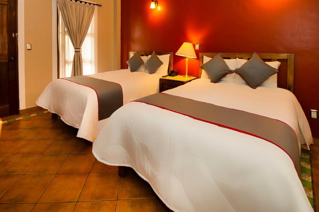 Postel nebo postele na pokoji v ubytování La Casona Tequisquiapan Hotel & Spa