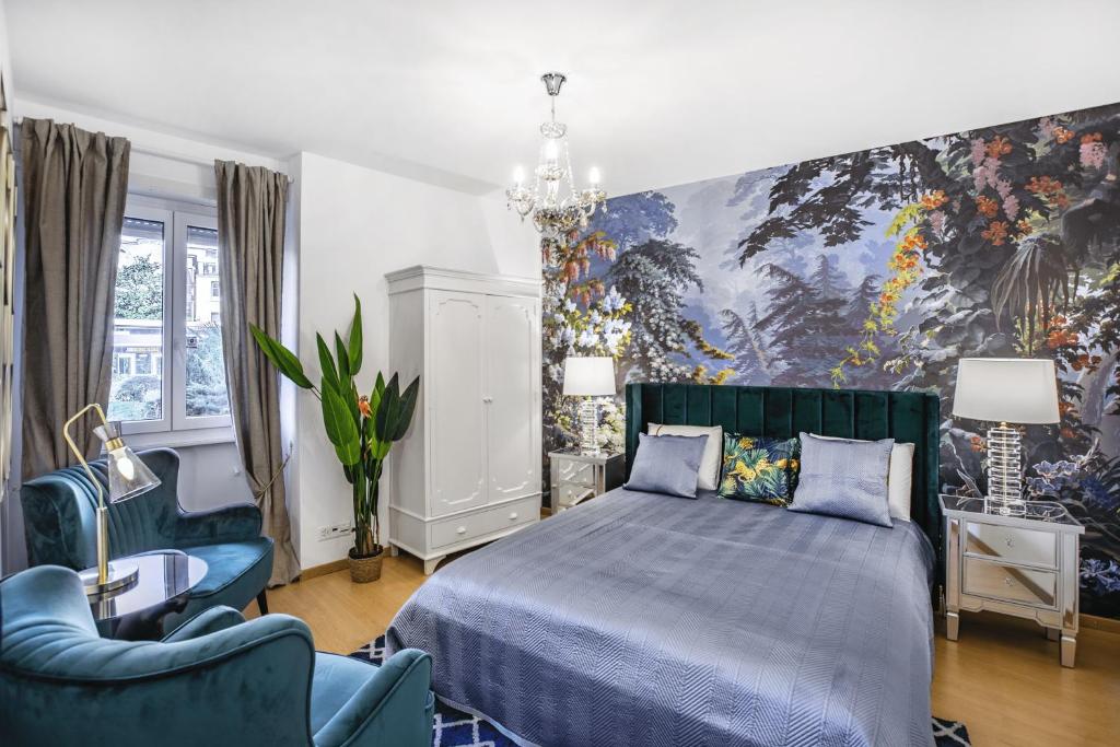 a bedroom with a bed and two blue chairs at Oasis 2 bedroom apartment in Montreux centre in Montreux