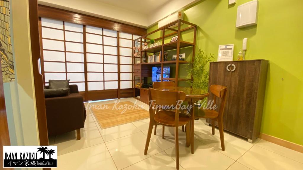 a dining room with a table and chairs in a room at Sea View & Pool View & WiFi & Netflix at Iman Kazoku TimurBay Ville Studio 2BDR in Kuantan
