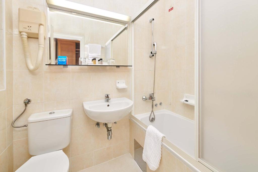 a bathroom with a toilet and a sink and a shower at Apartments Bellevue Plava Laguna in Poreč