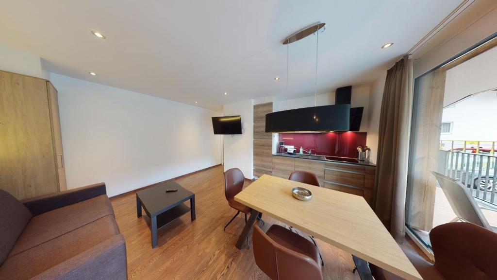 Televízia a/alebo spoločenská miestnosť v ubytovaní Appartement Kitzsteinhorn -Summercard included