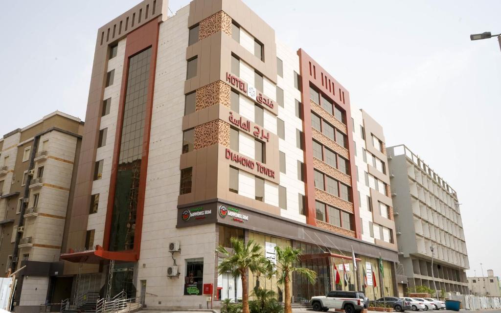 a building on a street with cars parked in front of it at Diamond Tower Hotel in Jeddah