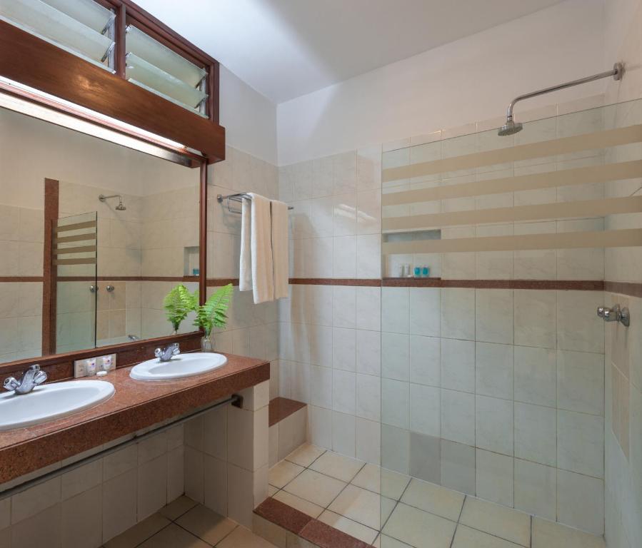 a bathroom with a sink, toilet and tub at Diamonds Leisure Beach & Golf Resort in Diani Beach