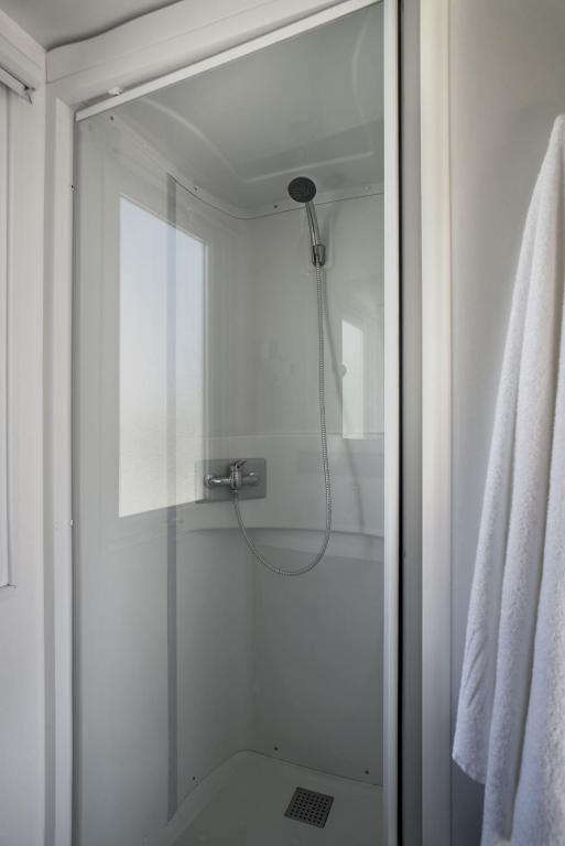 a shower with a glass door in a bathroom at Villaggio San Francesco in Duna Verde