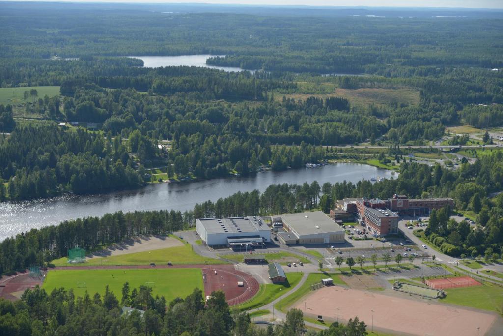 an aerial view of a building next to a river at Sport & Spa Hotel Vesileppis in Leppävirta