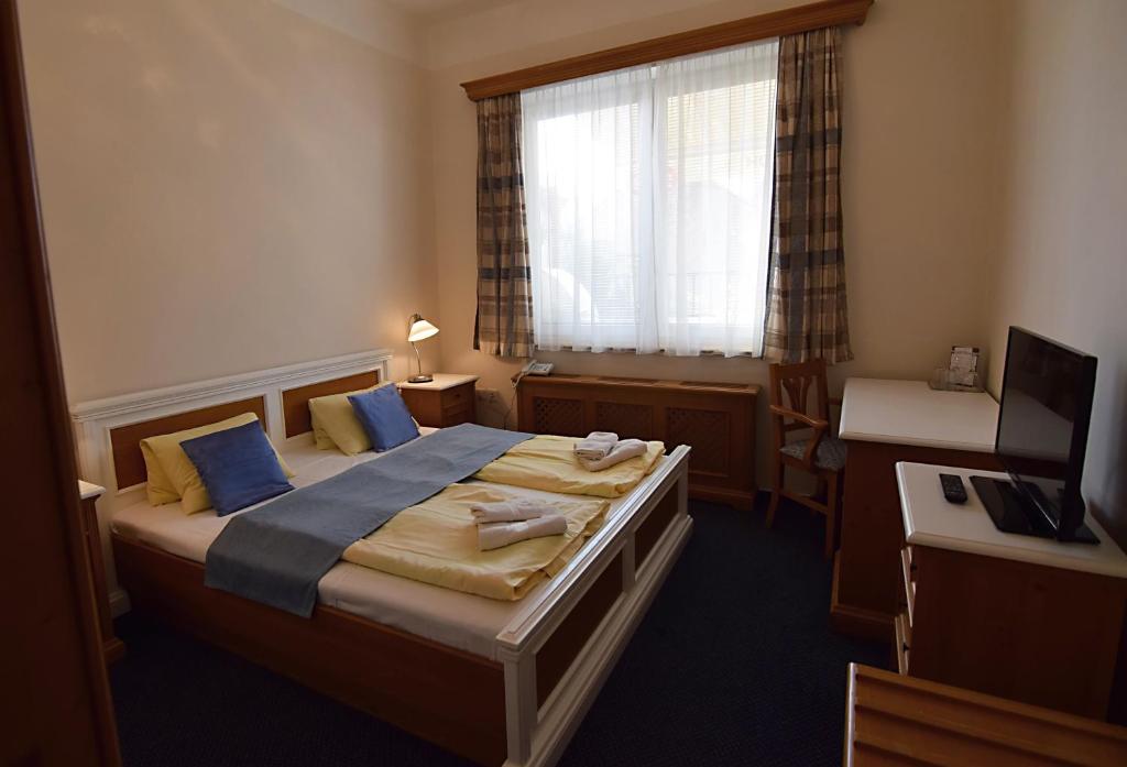 Postel nebo postele na pokoji v ubytování Hotel Soudek
