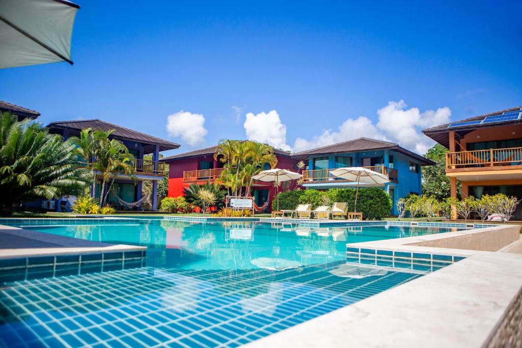 a swimming pool in front of some houses at BELLA VISTA Village in Arraial d'Ajuda