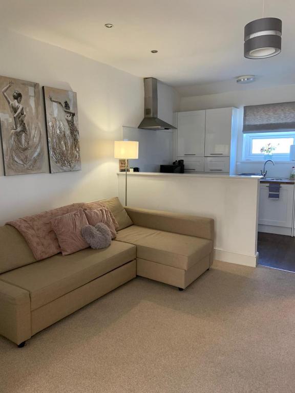 a living room with a couch and a kitchen at Durham Serviced Properties in Durham