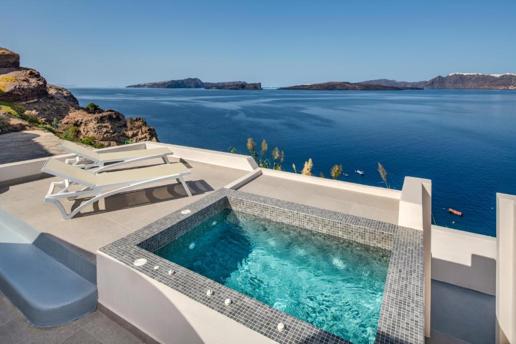 a swimming pool on a house with a view of the water at Kokkinos Villas in Akrotiri