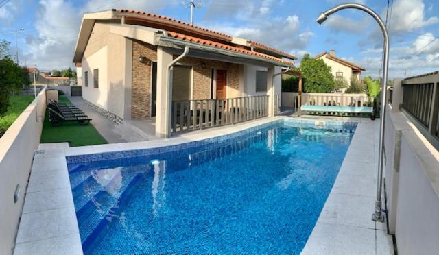 a swimming pool in front of a house at Paradise Property,Ideal para ferias ou Lua de Mel in Albergaria-a-Velha