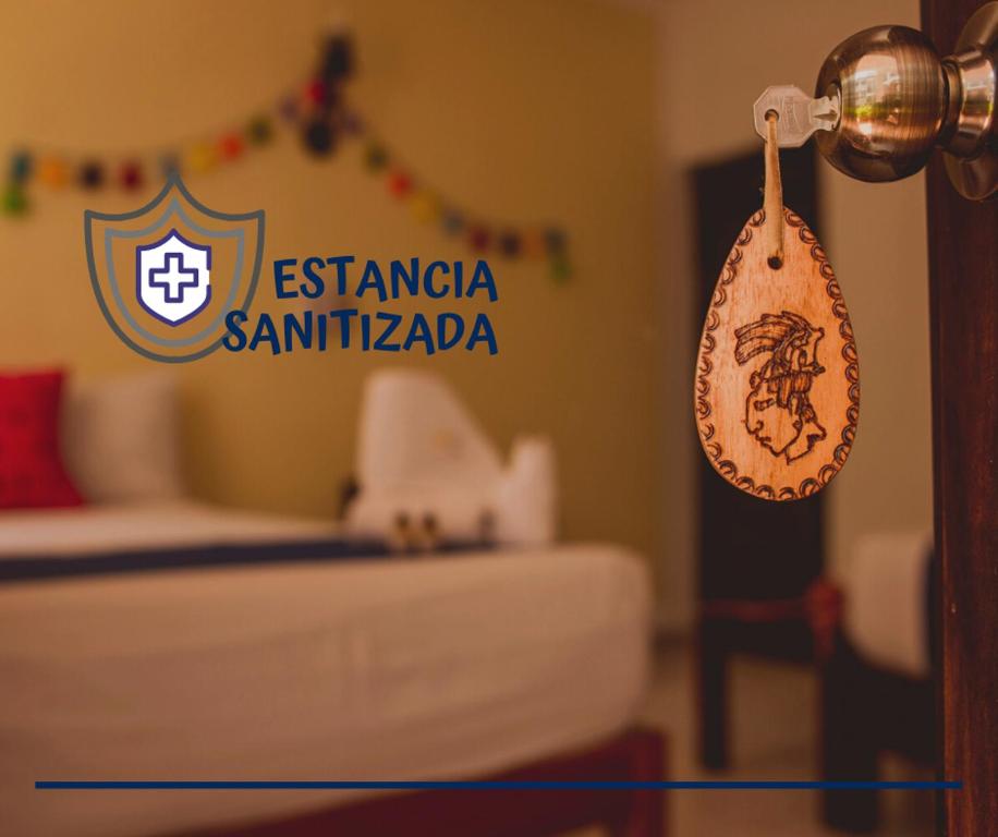 a hotel room with a sign on a door at Posada Kin in Palenque