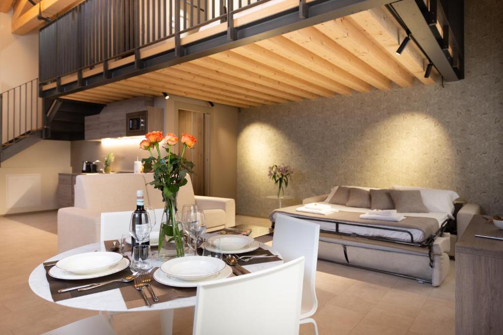 a dining room with a table and a bed at Residence 8 Loft in Venice