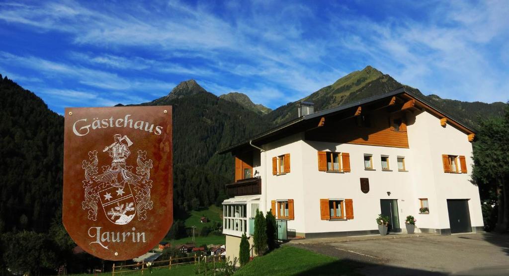 ein Gebäude mit einem Schild davor in der Unterkunft Gästehaus Laurin in Sankt Gallenkirch