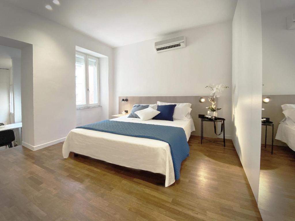 a bedroom with a large bed with blue and white pillows at Affittacamere del Prione in La Spezia