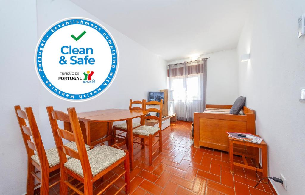 a dining room with a table and chairs and a sign at B14 - Heart of Old Town Apartment in Lagos