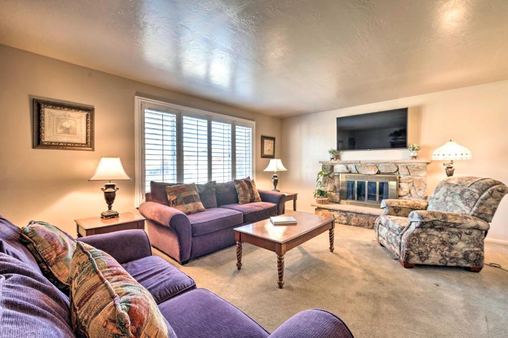 a living room with two couches and a fireplace at Updated Ranch Apartment with Deck - 9 Mi to Downtown in Taylorsville