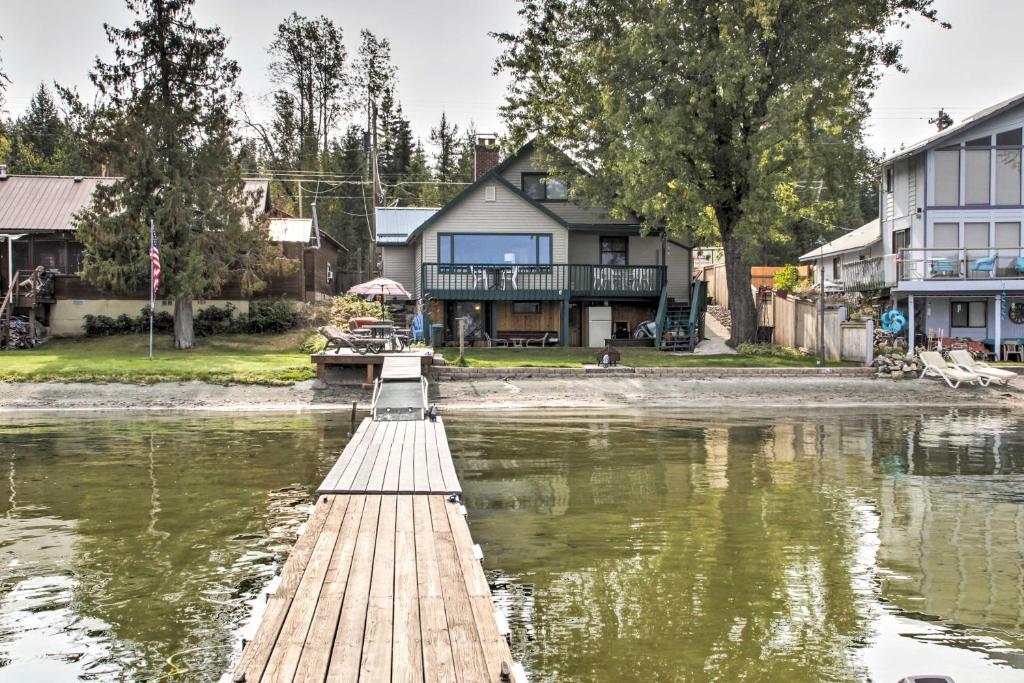 a dock in the water in front of a house at Diamond Lake Home with Dock Close to 2 Ski Resorts! 