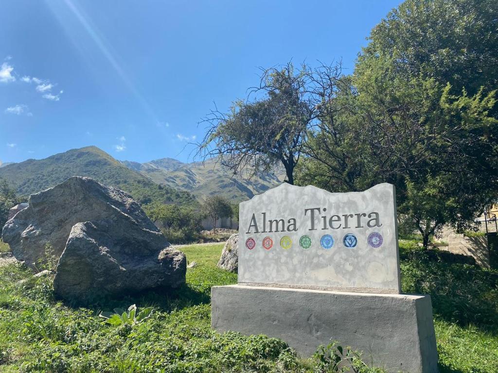 a sign for anima terraza with mountains in the background at Alma Tierra in Merlo